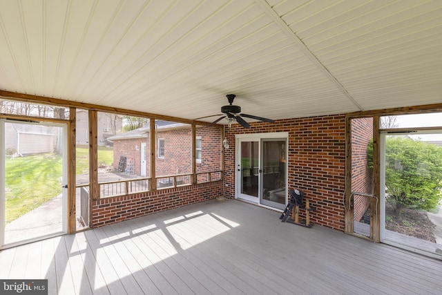 unfurnished sunroom with a ceiling fan
