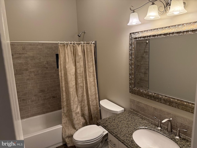 bathroom with vanity, toilet, and shower / tub combo