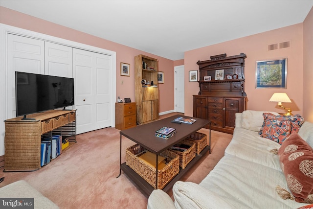 living room featuring light carpet and visible vents