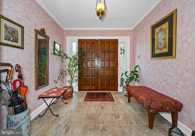 foyer with crown molding, baseboards, stone finish floor, and wallpapered walls