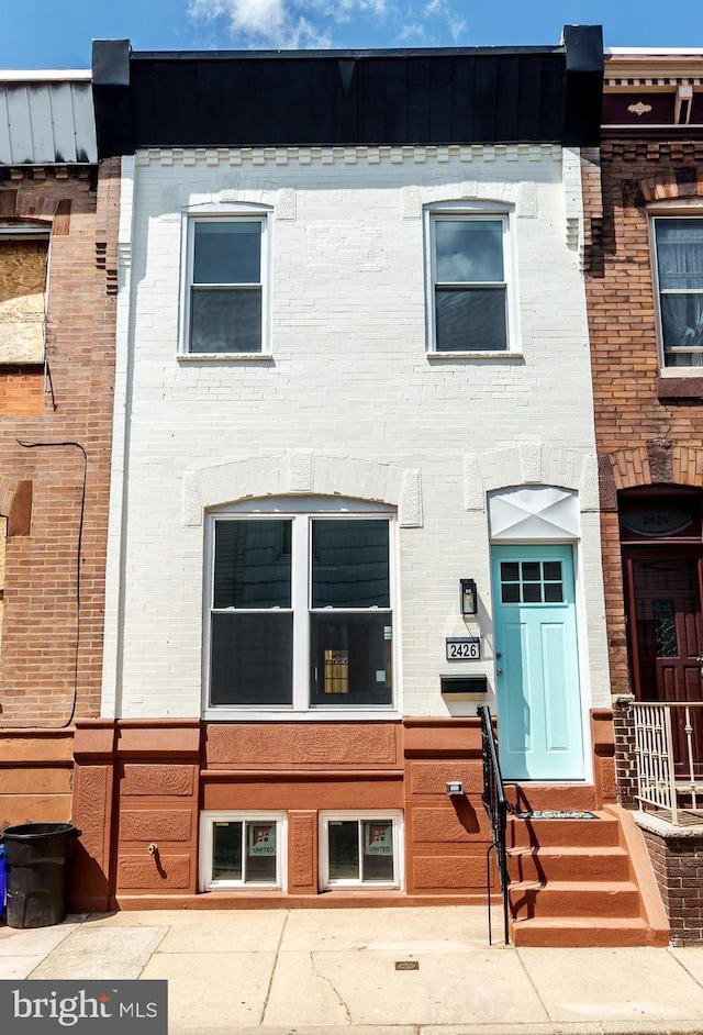 townhome / multi-family property featuring brick siding