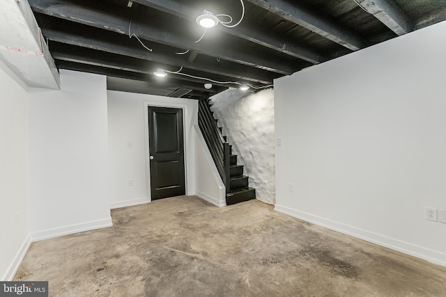 finished below grade area with baseboards and stairs