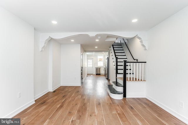 interior space with stairway, baseboards, light wood finished floors, and recessed lighting