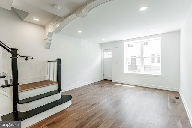 entrance foyer featuring baseboards, wood finished floors, recessed lighting, and stairs