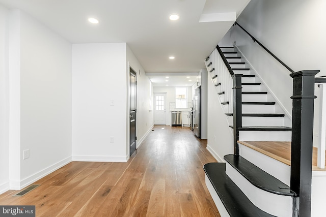 interior space featuring visible vents, stairs, light wood finished floors, and recessed lighting