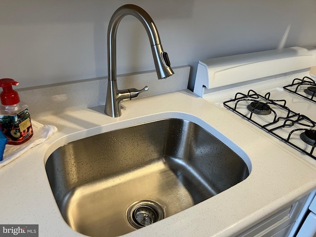 interior details with a sink and light countertops