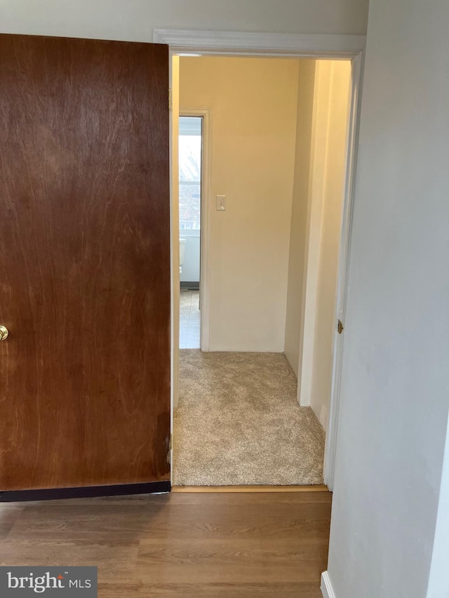 hall with wood finished floors