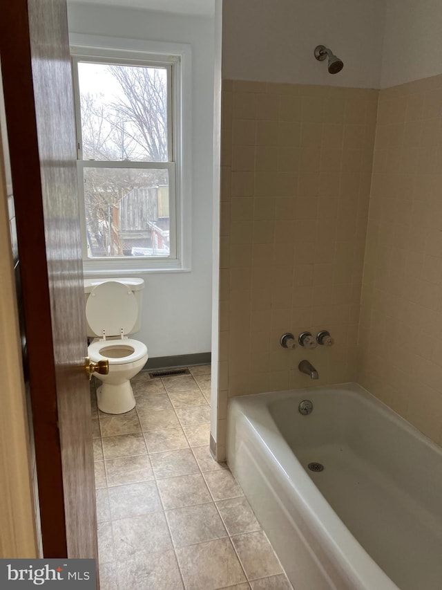 full bathroom featuring toilet, baseboards, shower / washtub combination, and tile patterned flooring