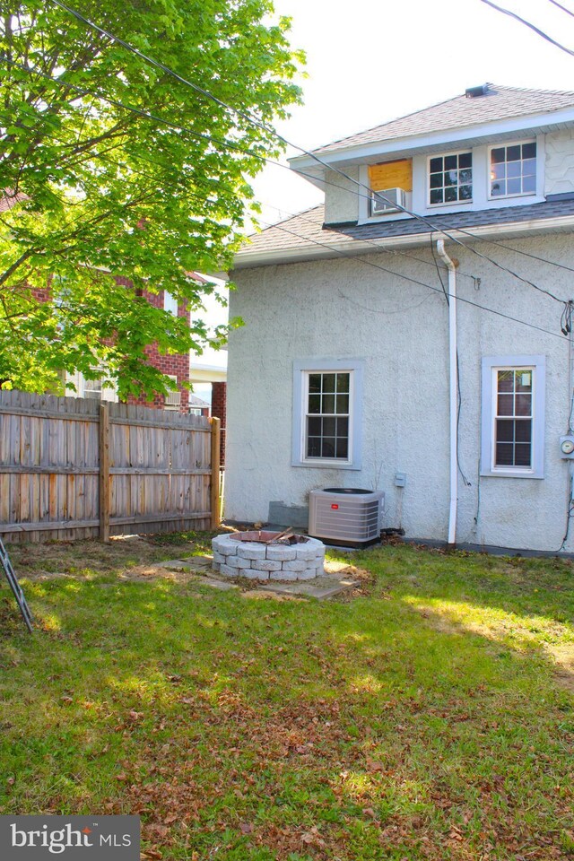 408 Prince George St, Cumberland, MD 21502 - rear view of house featuring central AC, stucco siding, and a fire pit