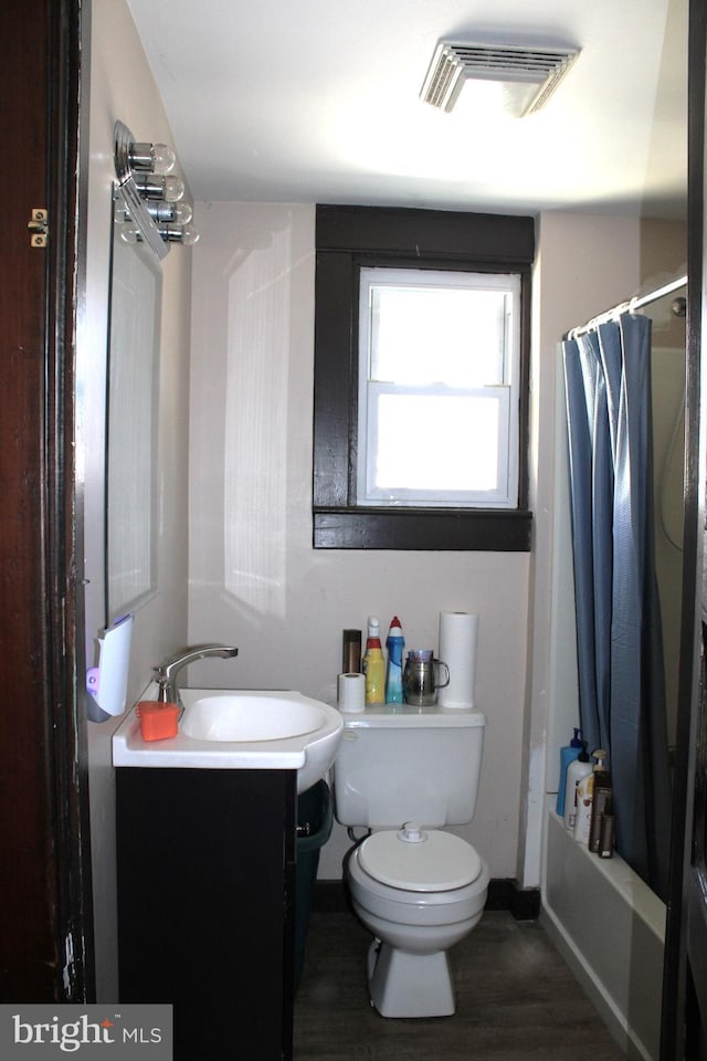 408 Prince George St, Cumberland, MD 21502 - full bath with toilet, vanity, wood finished floors, and shower / bath combo