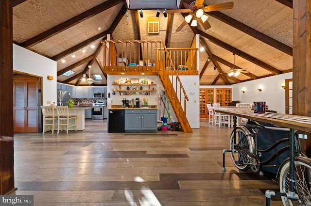 2436 Warm Springs Rd, Shenandoah Junction, WV 25442 - living room with a ceiling fan, beamed ceiling, hardwood / wood-style flooring, high vaulted ceiling, and stairway