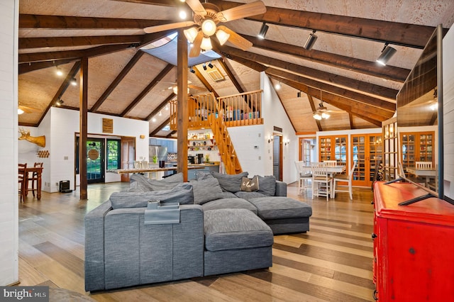 2436 Warm Springs Rd, Shenandoah Junction, WV 25442 - living room with a ceiling fan, track lighting, wood finished floors, high vaulted ceiling, and stairs