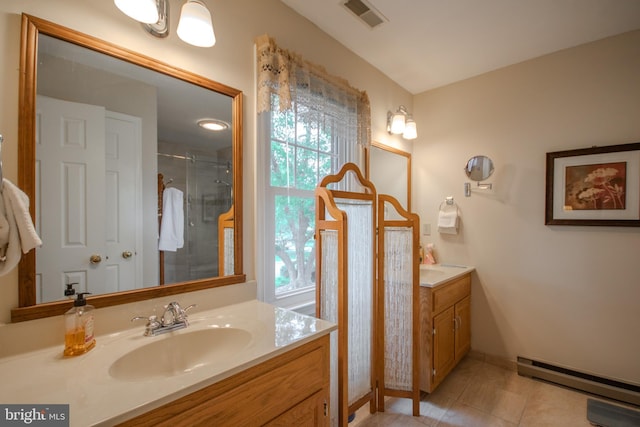 full bathroom with a baseboard heating unit, vanity, visible vents, a stall shower, and tile patterned flooring
