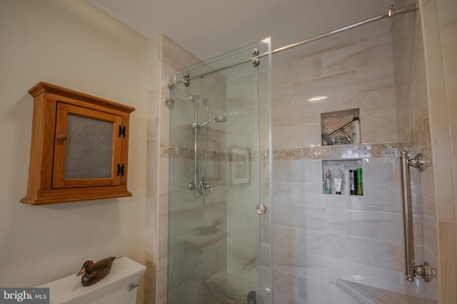full bathroom with a shower stall and toilet