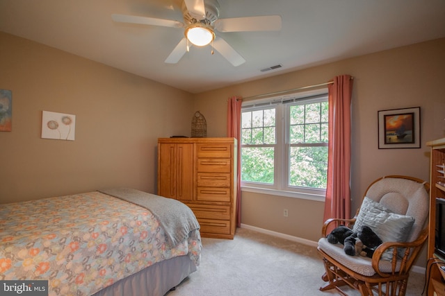 bedroom featuring baseboards, a ceiling fan, visible vents, and light colored carpet