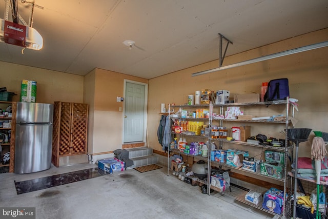 garage with freestanding refrigerator and a garage door opener