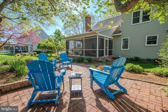 view of patio featuring a sunroom