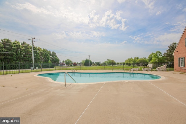 view of pool with a patio area, a fenced in pool, and fence