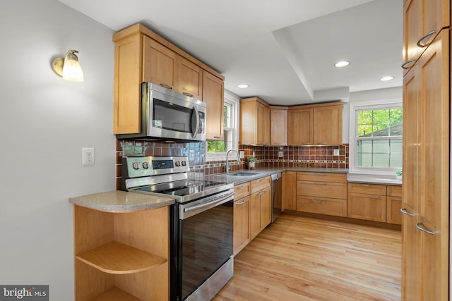 kitchen featuring open shelves, stainless steel appliances, recessed lighting, light wood-type flooring, and backsplash