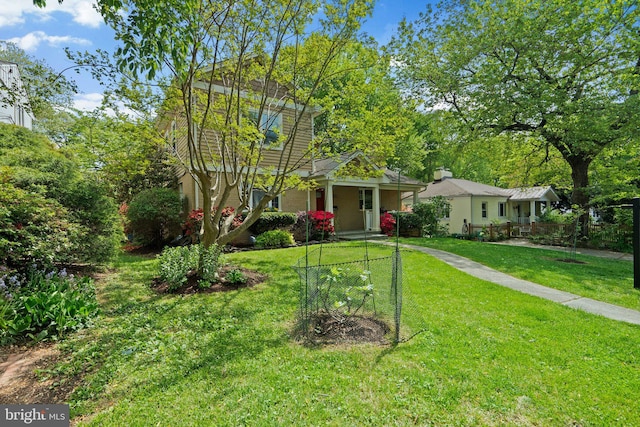 view of front of home with covered porch and a front yard