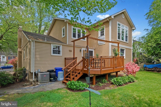 back of property featuring a chimney, a lawn, a wooden deck, central air condition unit, and fence
