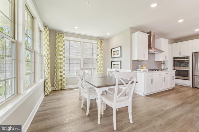dining area with baseboards, recessed lighting, a wealth of natural light, and light wood finished floors