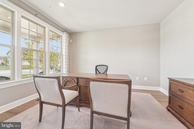 home office with baseboards and light wood-type flooring