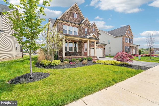 craftsman-style home featuring covered porch, concrete driveway, a front yard, and brick siding