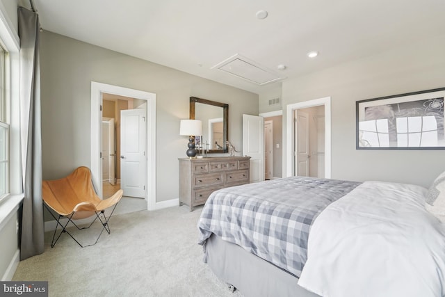 bedroom with attic access, visible vents, light carpet, and baseboards