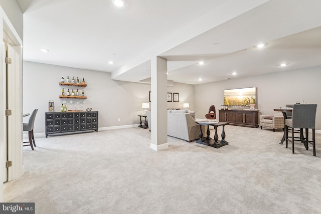 interior space with carpet, recessed lighting, a bar, and baseboards