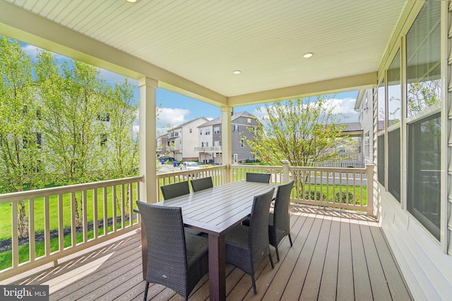 deck with a residential view and outdoor dining space