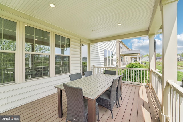 deck with covered porch and outdoor dining area