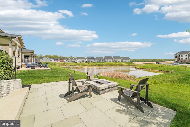 view of patio / terrace with a residential view, a water view, and an outdoor fire pit