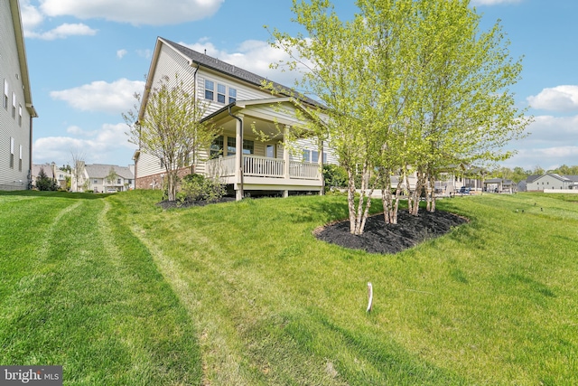 back of property featuring a residential view and a lawn