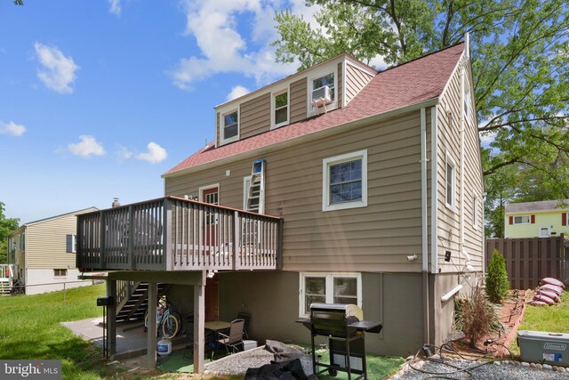 13432 Forest Glen Rd, Woodbridge, VA 22191 - back of property with fence, roof with shingles, a wooden deck, stairway, and a lawn