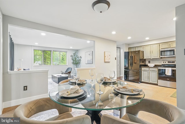 dining room with baseboards and recessed lighting