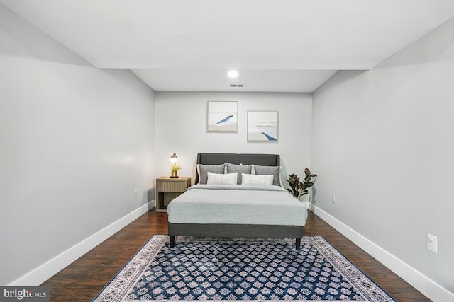 bedroom with baseboards, dark wood-style flooring, and visible vents