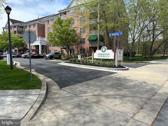 view of road with street lighting, sidewalks, and curbs