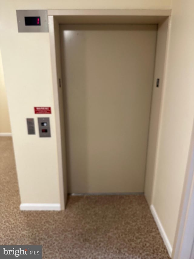 interior space with carpet floors and elevator