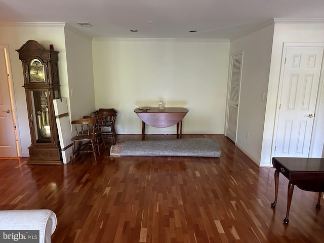 dining room with crown molding, baseboards, wood finished floors, and visible vents