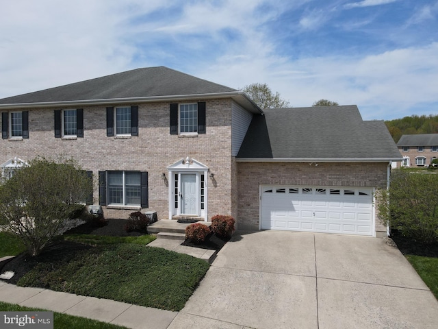 colonial home featuring concrete driveway, an attached garage, brick siding, and a front yard