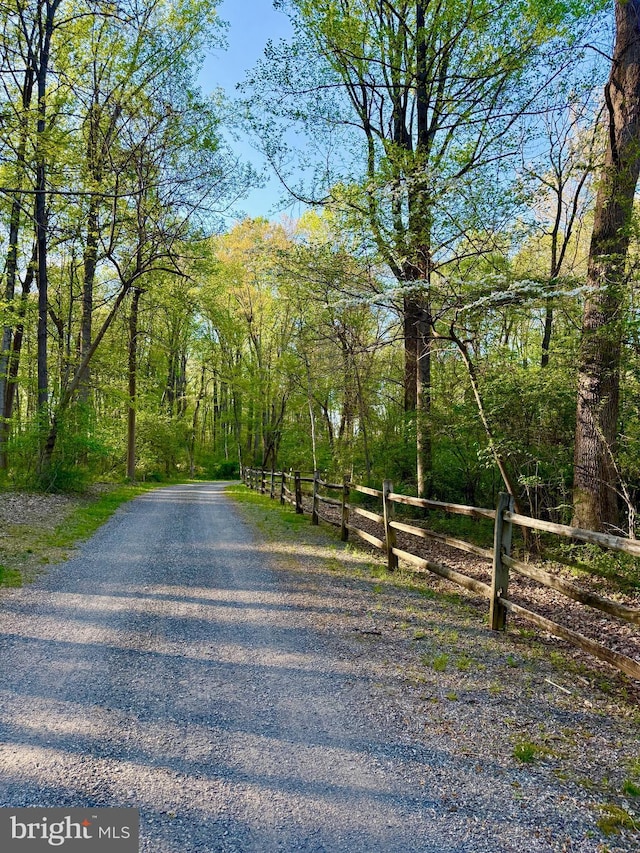 view of road featuring a forest view