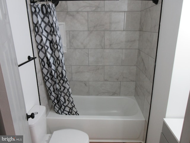 bathroom with toilet and shower / bath combo with shower curtain
