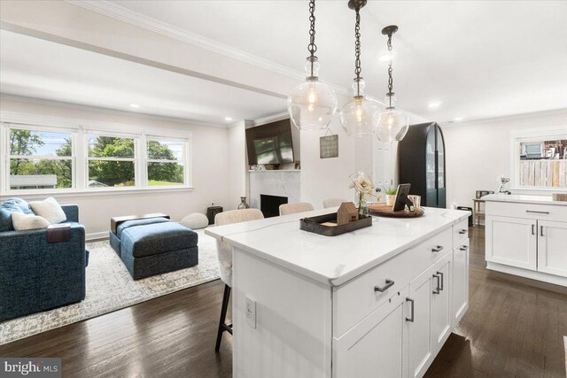 kitchen with a kitchen island, open floor plan, a wealth of natural light, and a kitchen bar