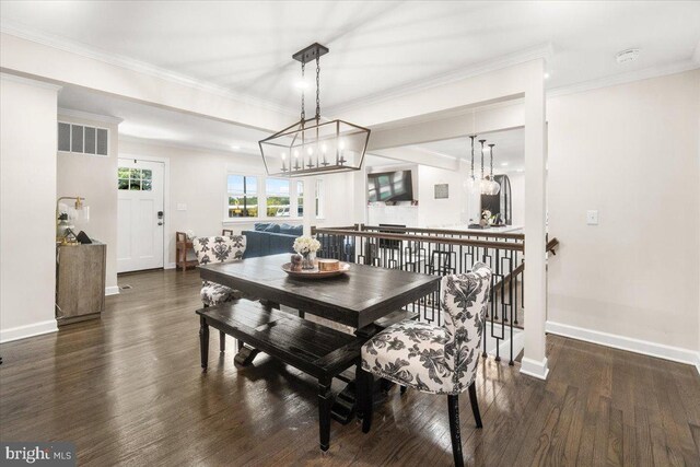 dining room featuring baseboards, wood finished floors, and a notable chandelier