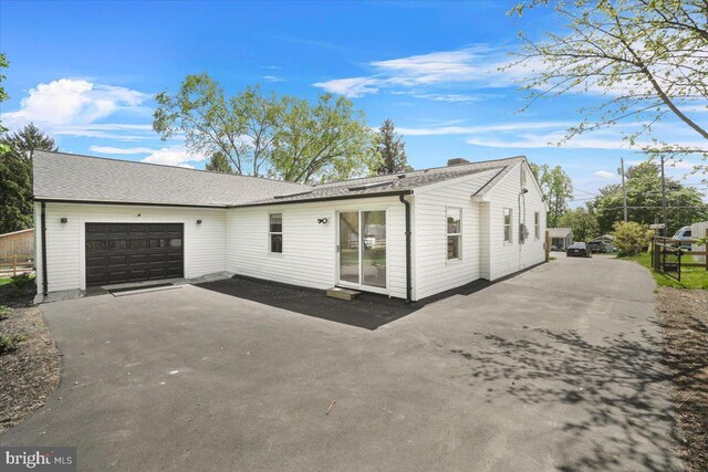 view of front of house with a garage and aphalt driveway