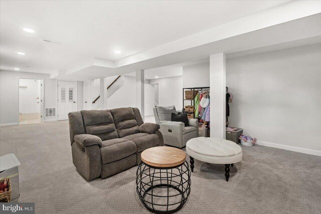 living area with recessed lighting, baseboards, stairway, and carpet