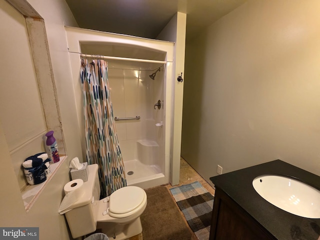 bathroom featuring vanity, a shower with shower curtain, and toilet