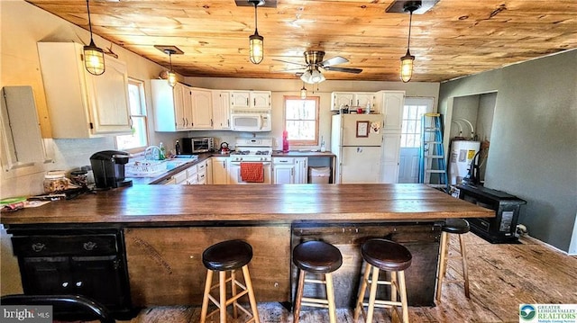 kitchen with wooden ceiling, dark countertops, a ceiling fan, and white appliances