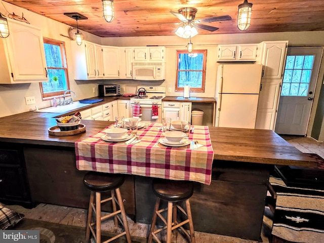 kitchen featuring plenty of natural light, wood ceiling, and white appliances